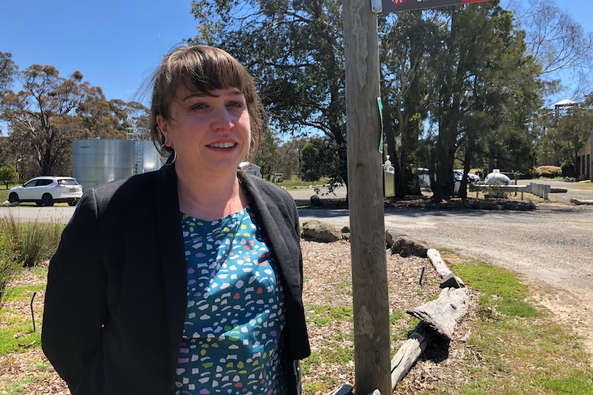 Woman looks concerned, in outdoor education camp setting.