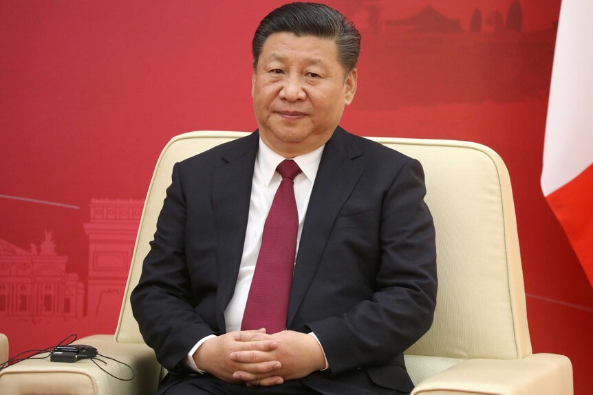Xi Jinping sits in a meeting