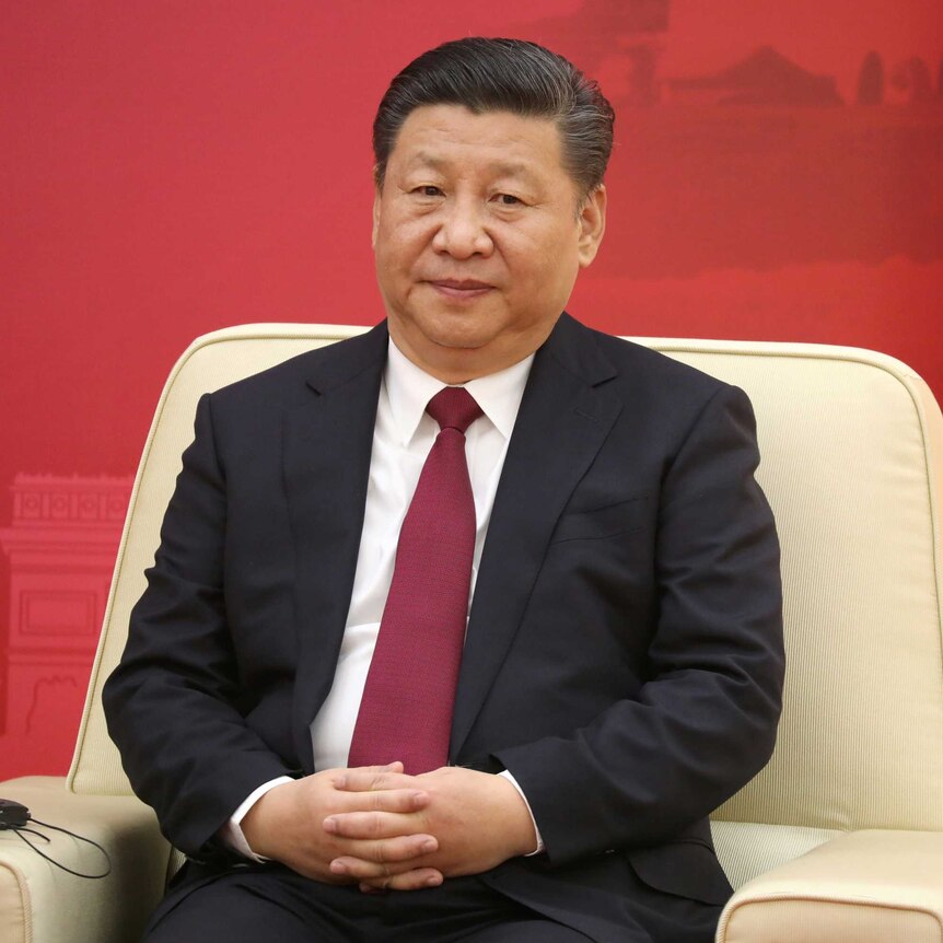 Xi Jinping sits in a meeting