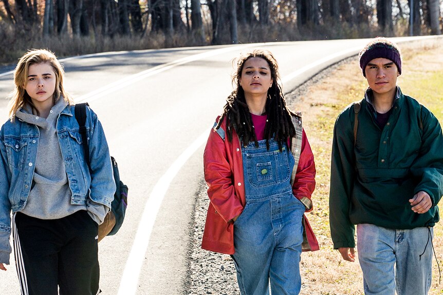 Chloë Grace Moretz, Forrest Goodluck and Sasha Lane walking on a road in film The Miseducation of Cameron Post.