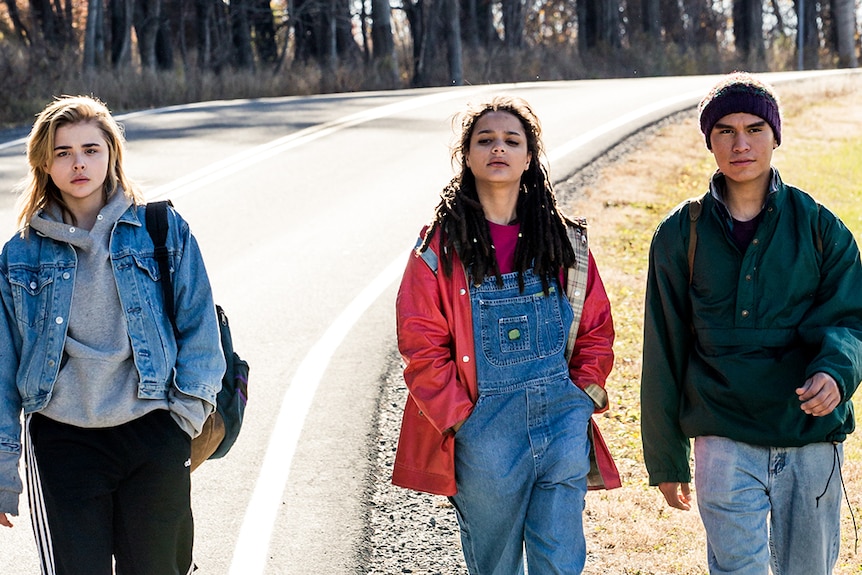 Chloë Grace Moretz, Forrest Goodluck and Sasha Lane walking on a road in film The Miseducation of Cameron Post.