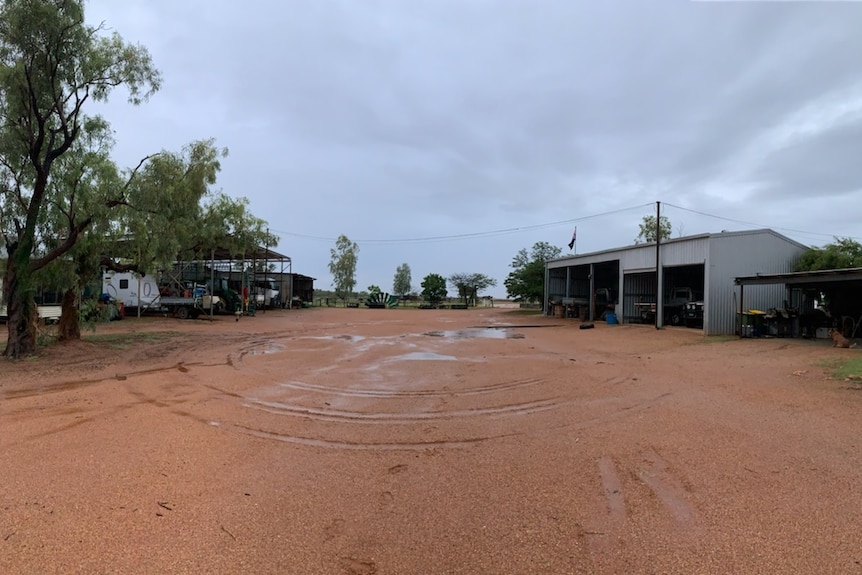 Puddles form on red earth on Mayor Britton's station.