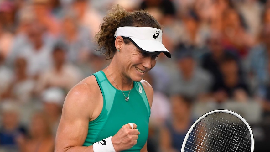 Samantha Stosur pumps her fist and smiles after winning a point