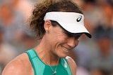 Samantha Stosur pumps her fist and smiles after winning a point