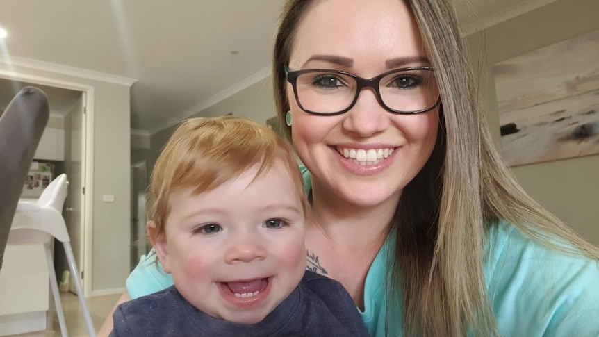 woman and toddler smiling at camera 