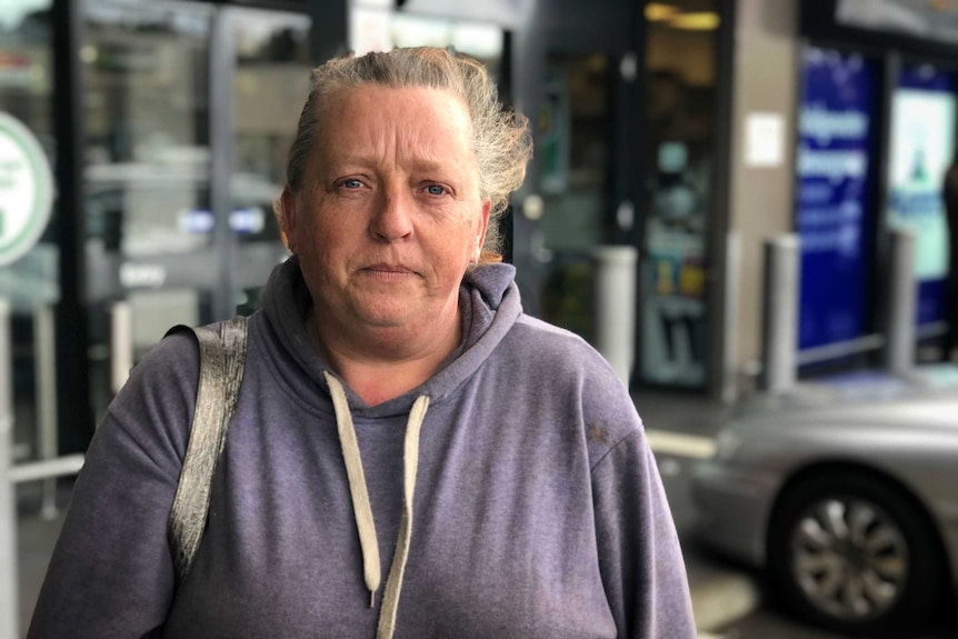 A woman poses outside a shopping centre in Bridgewater. She has a neutral expression