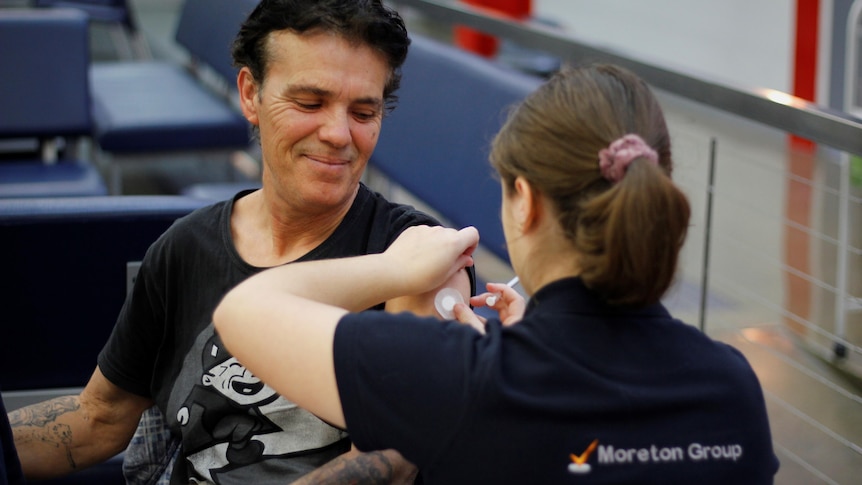 A man receiving a COVID-19 vaccination.