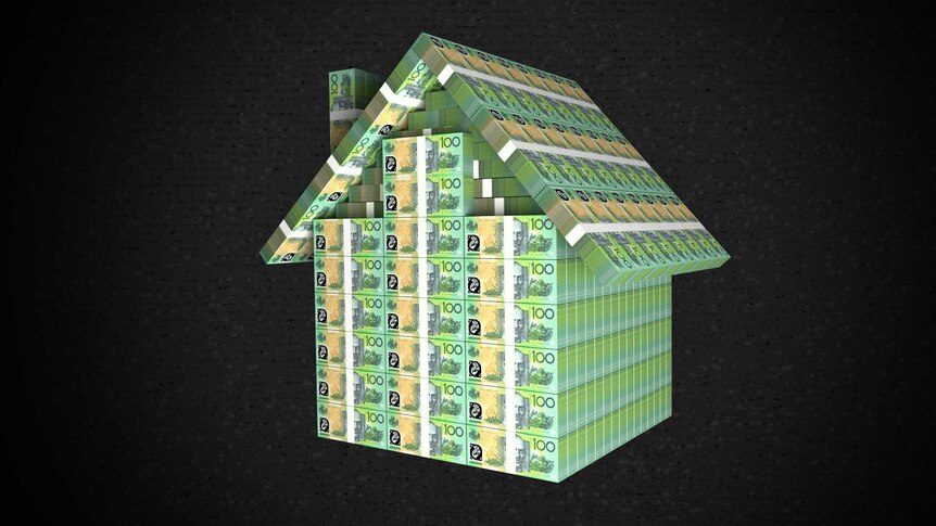 $100 notes built up in the shape of a house