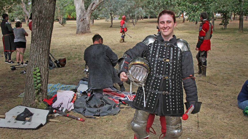 Lady dressed in heavy armour in a park in Canberra