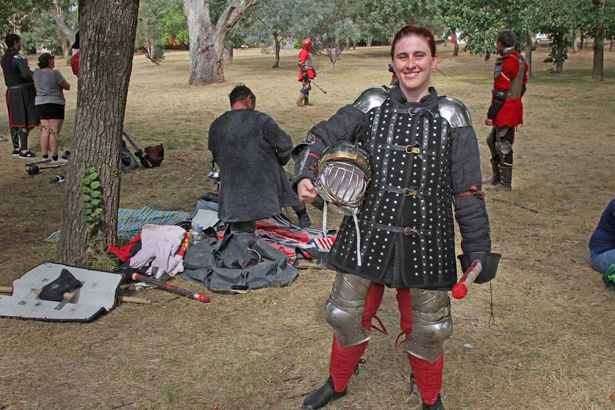 Lady dressed in heavy armour in a park in Canberra