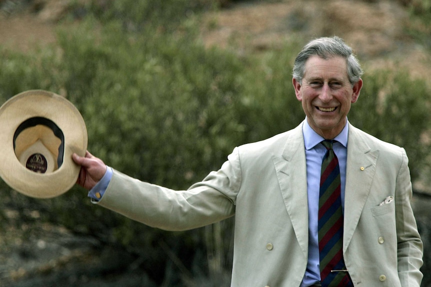 Prince Charles waves his hat