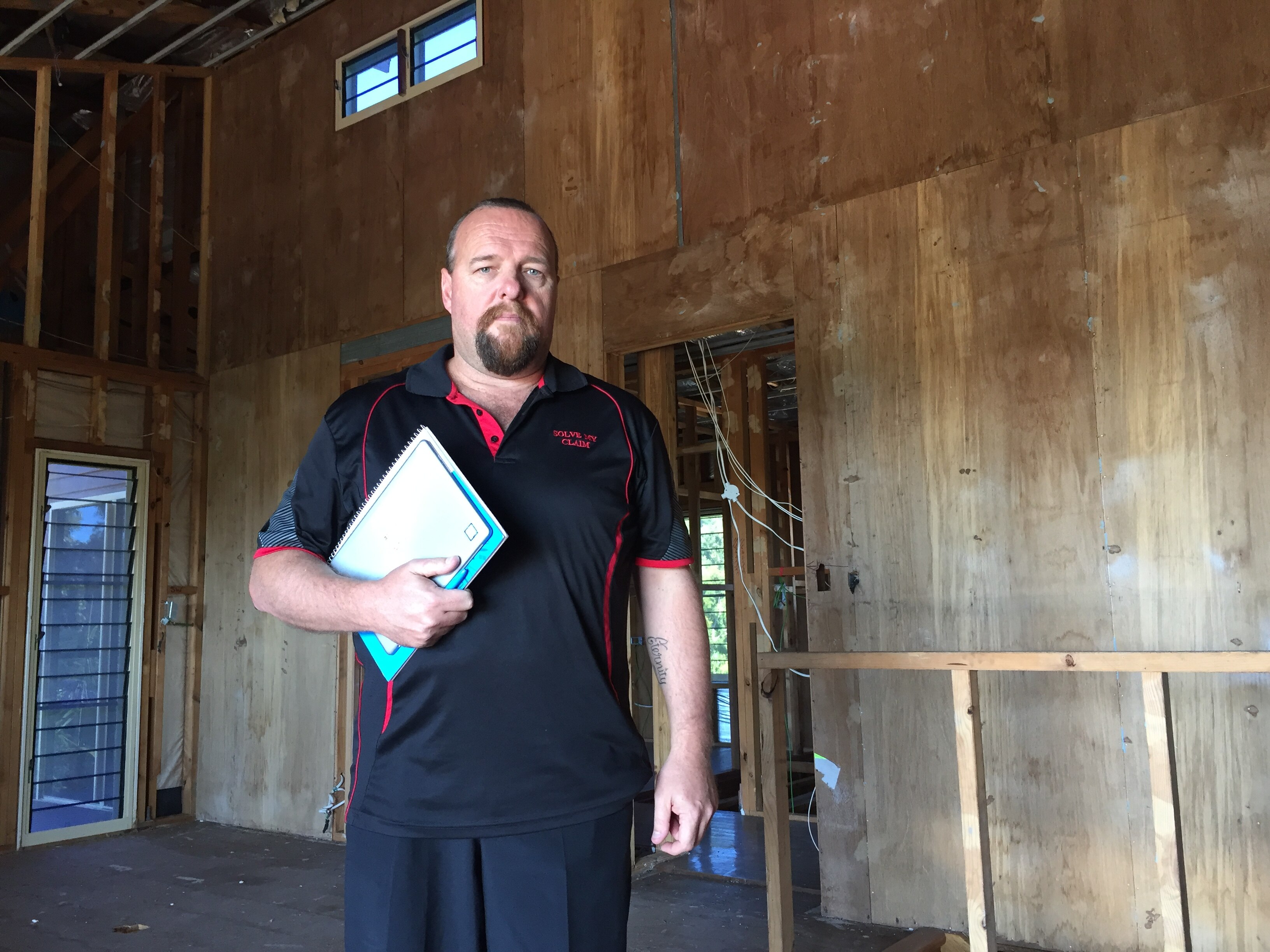 David Keane inside a damaged house still awaiting repairs