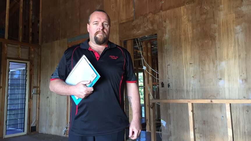 David Keane inside a damaged house still awaiting repairs