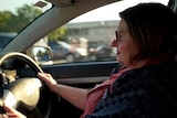 woman behind the steering wheel in a car