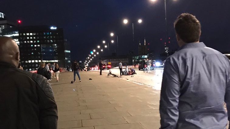 Two men look at the aftermath of an incident on London Bridge, United Kingdom.