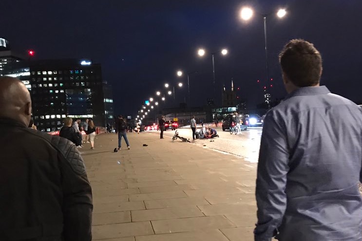Two men look at the aftermath of an incident on London Bridge, United Kingdom.
