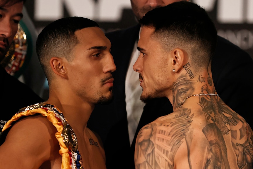 Teofimo Lopez and George Kambosos look into each other's eyes, shirtless