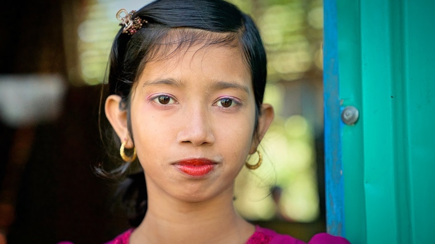 A close-up of a young girl with make-up on.