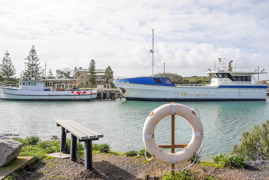 Marina with two large fishing boats tied to a jetty