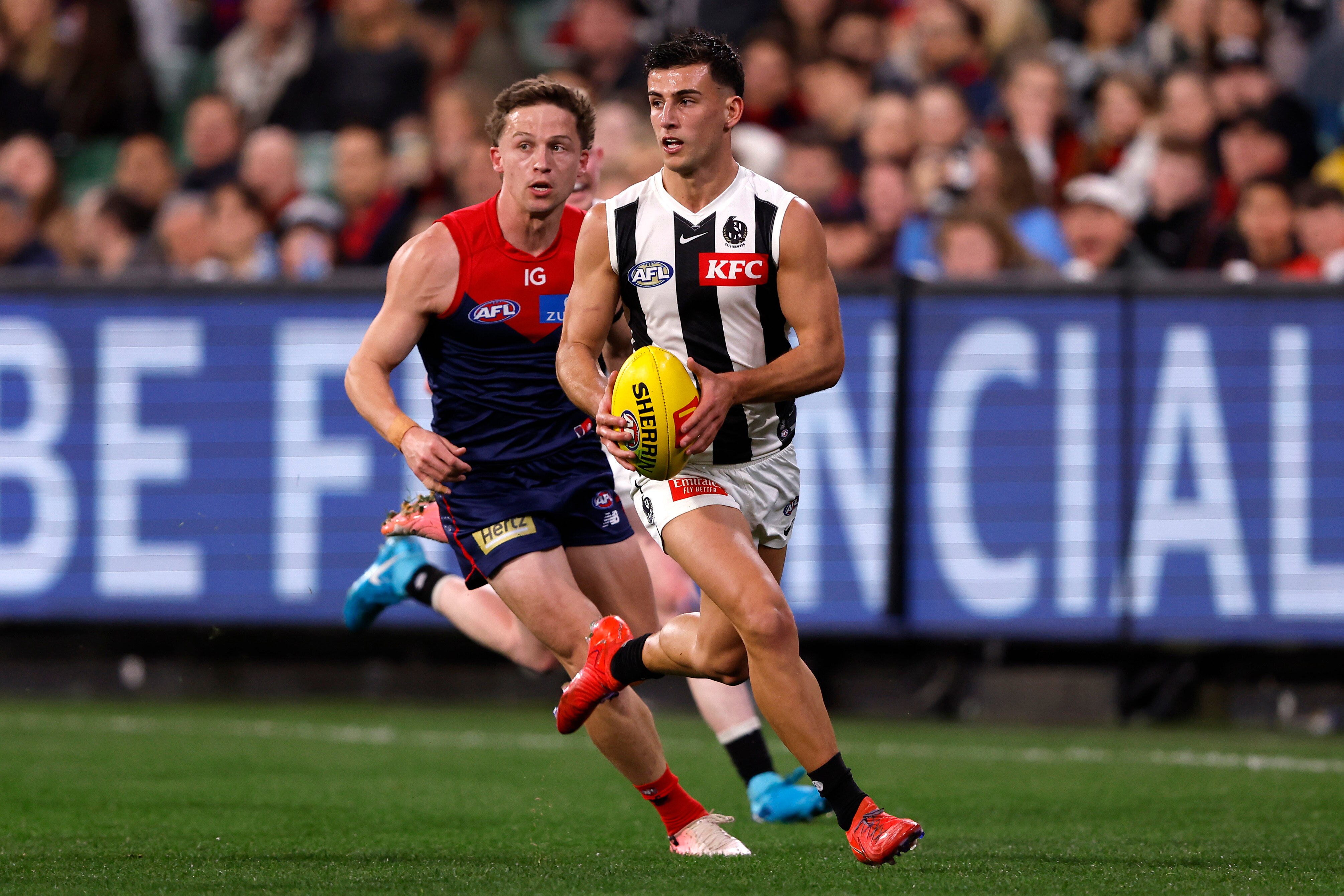 Nick Daicos runs with the football