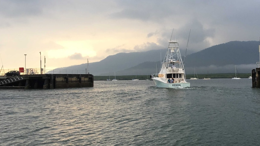 A 56-foot game fishing boat leaves the marina in Cairns