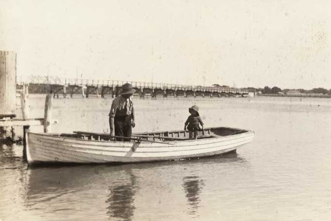 A man and boy in a rowboat at the third Canning Bridge, c1920.