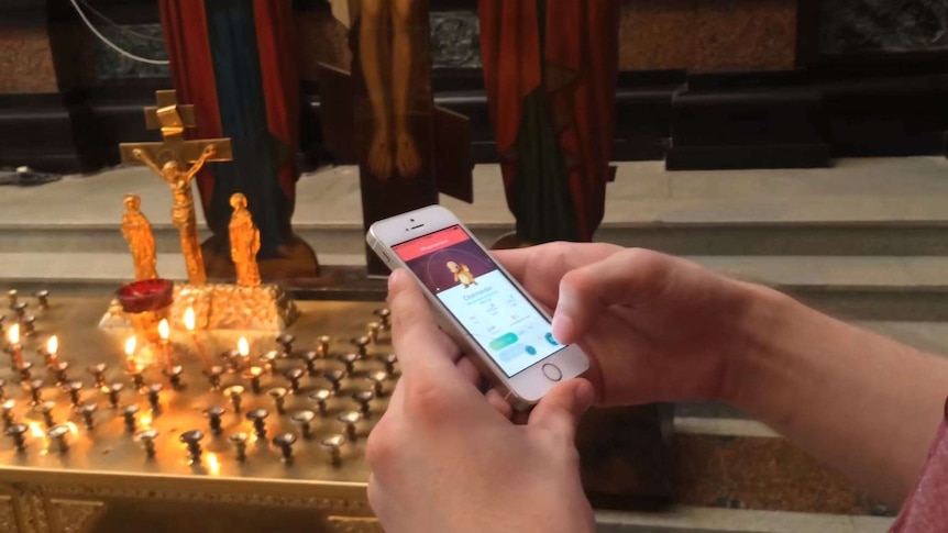A man plays Pokemon Go on his mobile phone in a Russian Orthodox church.