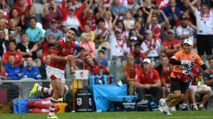 Gareth Widdop (L) celebrates kicking a conversion for the Dragons against the Panthers.