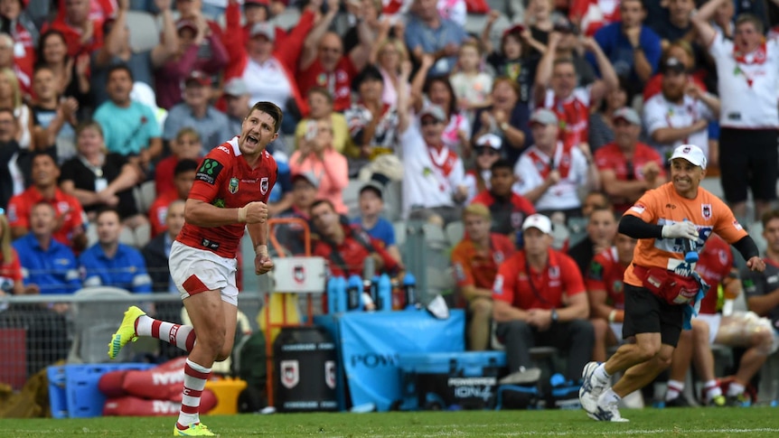 Gareth Widdop (L) celebrates kicking a conversion for the Dragons against the Panthers.