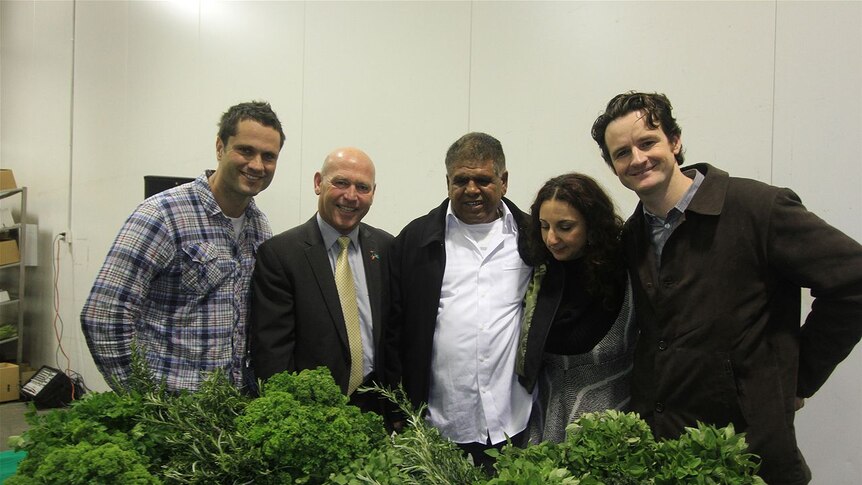 Ron Newchurch (centre) celebrates the launch of his new food Indigenous food company