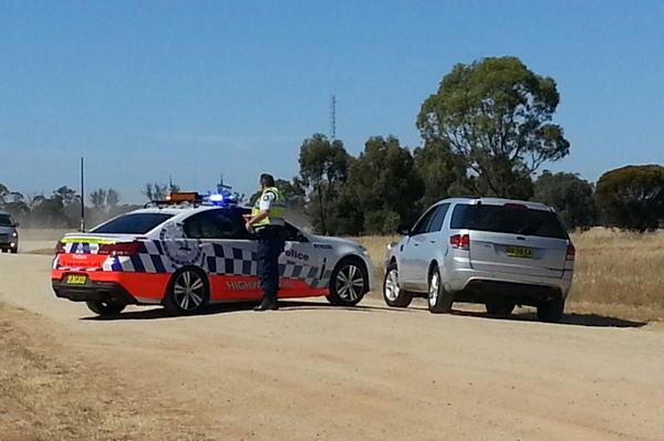 Police cars at Old Deniliquin Road, north of Moama where two people were found dead