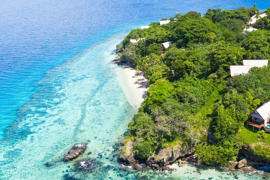 Drone image of island and turquoise waters.