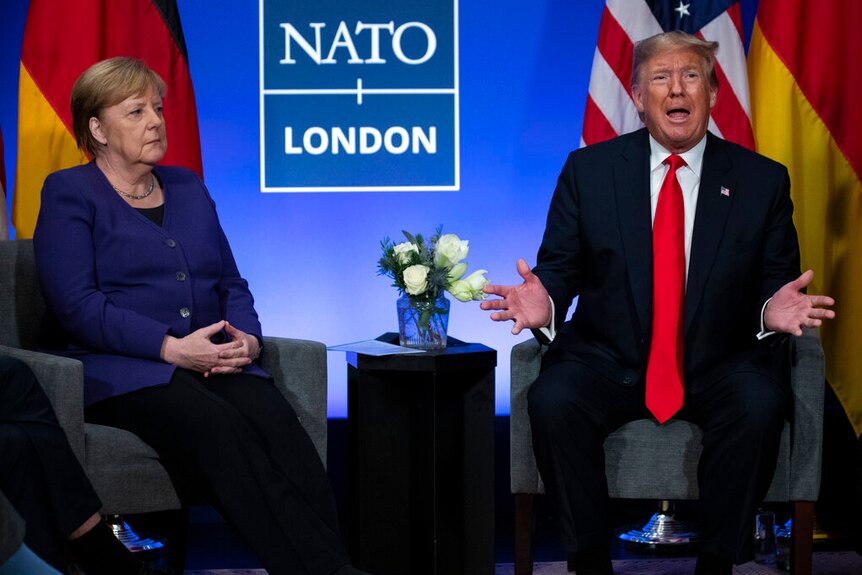 President Donald Trump during a meeting with German Chancellor Angela Merkel at the NATO summit at The Grove.