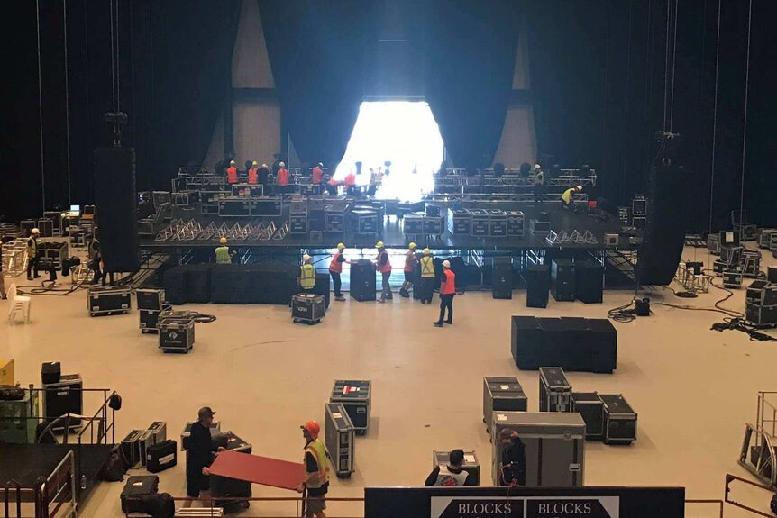 Workers set up equipment at the entertainment centre.