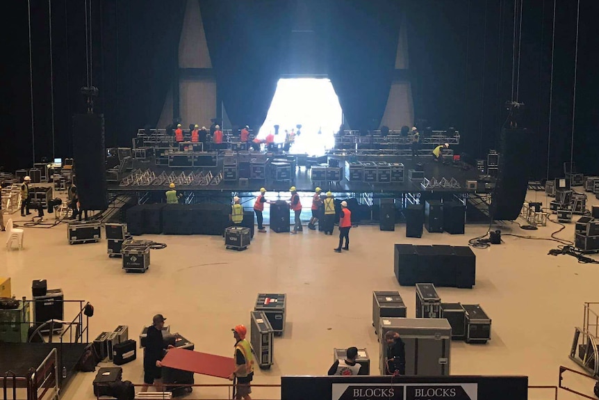 Workers set up equipment at the entertainment centre.