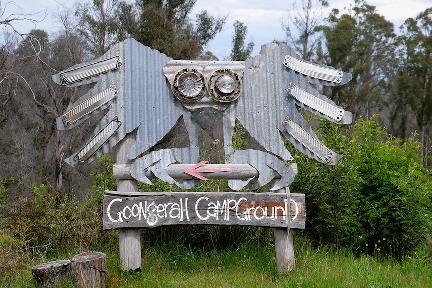 A large sign made from old roofing iron and timber points the way to the Goongerah Campground