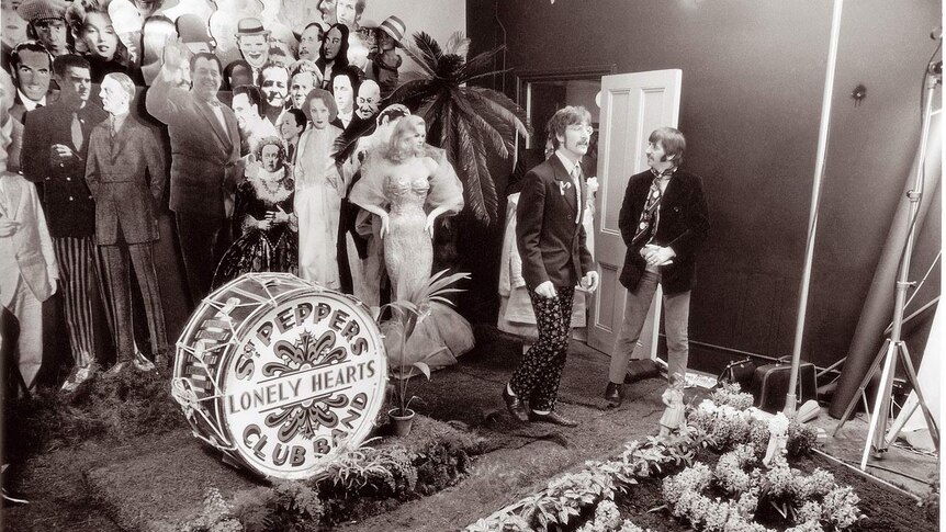 B&W photo of John Lennon, Ringo Starr and cardboard cut-outs during the making the cover for Sgt Pepper’s album (1967)