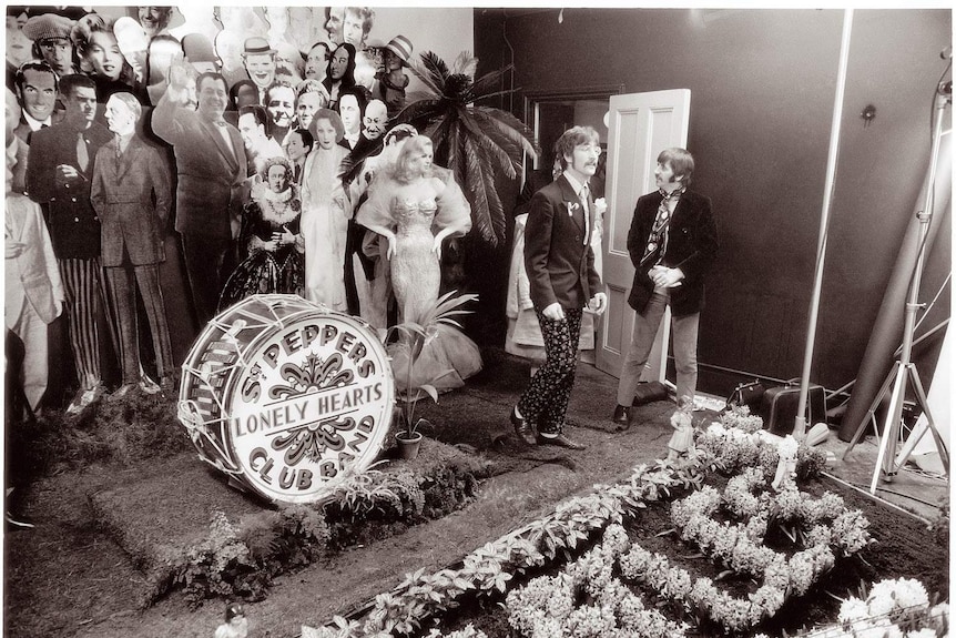 B&W photo of John Lennon, Ringo Starr and cardboard cut-outs during the making the cover for Sgt Pepper’s album (1967)