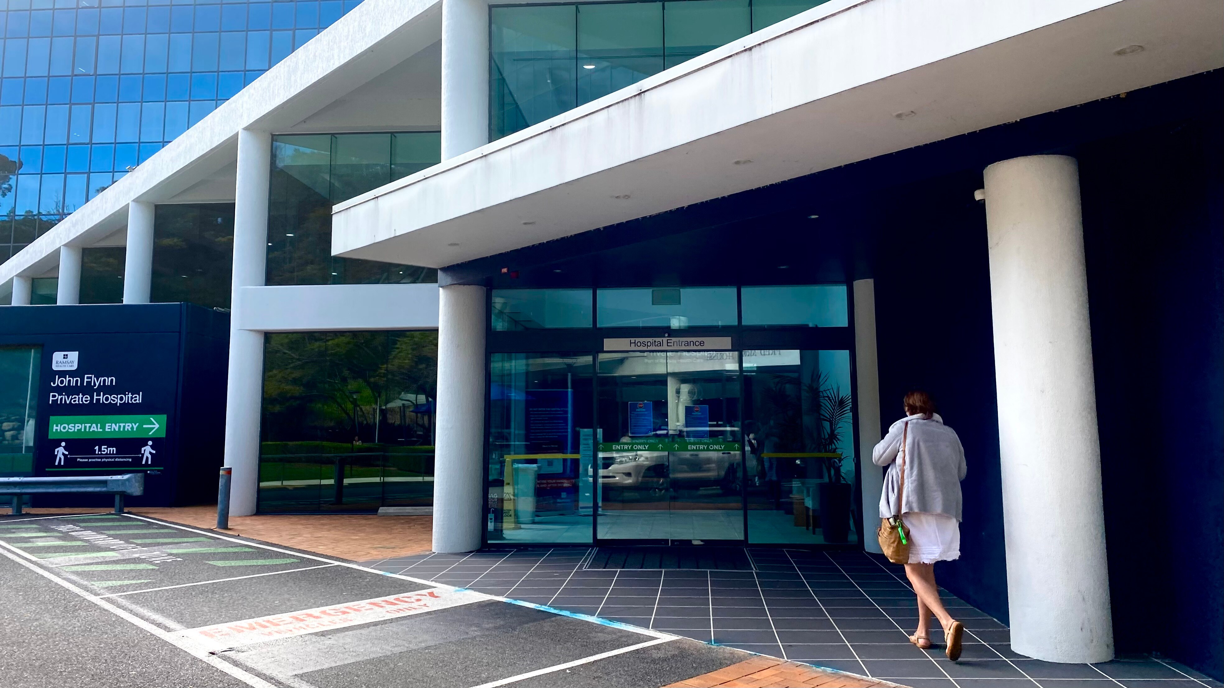 woman walking into entry of John Flynn hospital