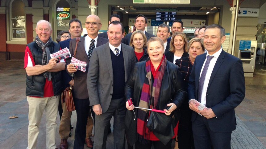 A group of Labor MPs stands outside Perth train station.