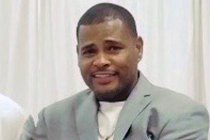A family photo of Ronald Greene wearing a grey suit
