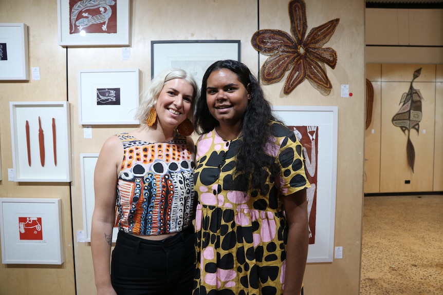 Katie Hagebols and Aysha Alderson, from Marrawuddi Arts and Culture centre in Jabiru, standing against a wall.