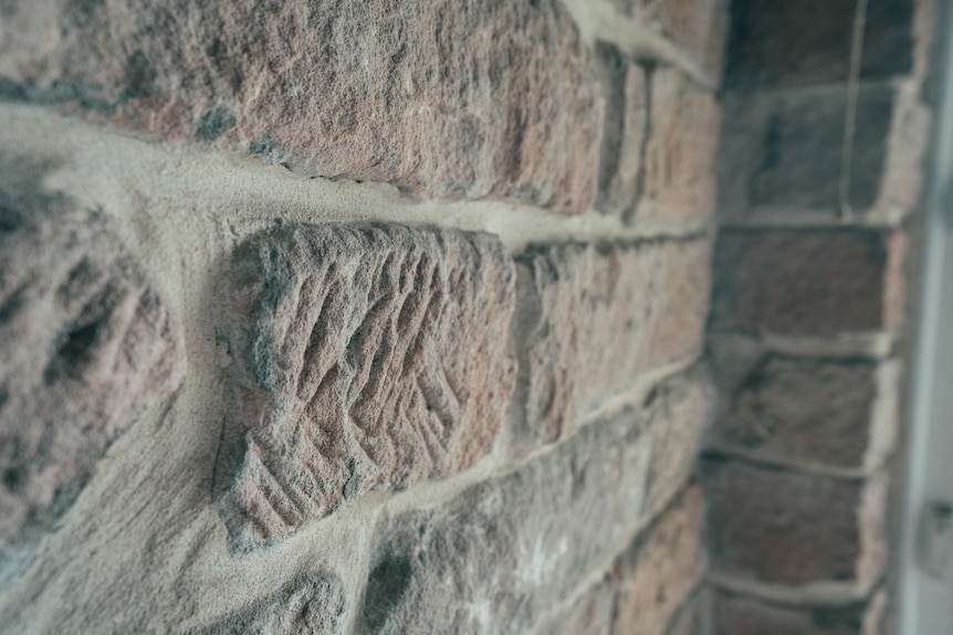 A close up of brick work with carvings in it