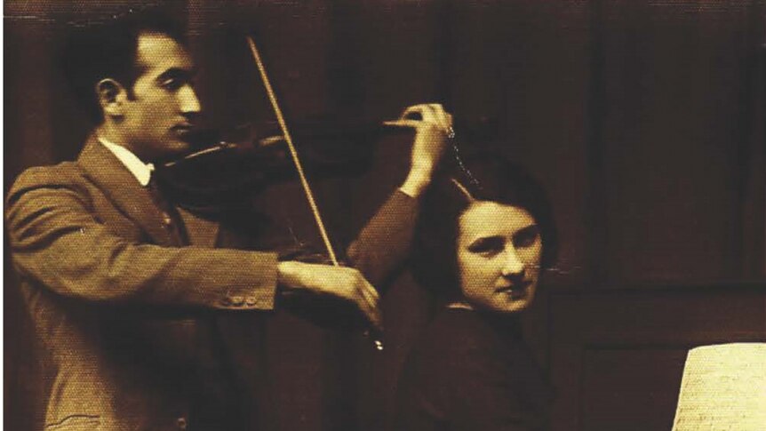 A violinist performs with a pianist, in historic times.