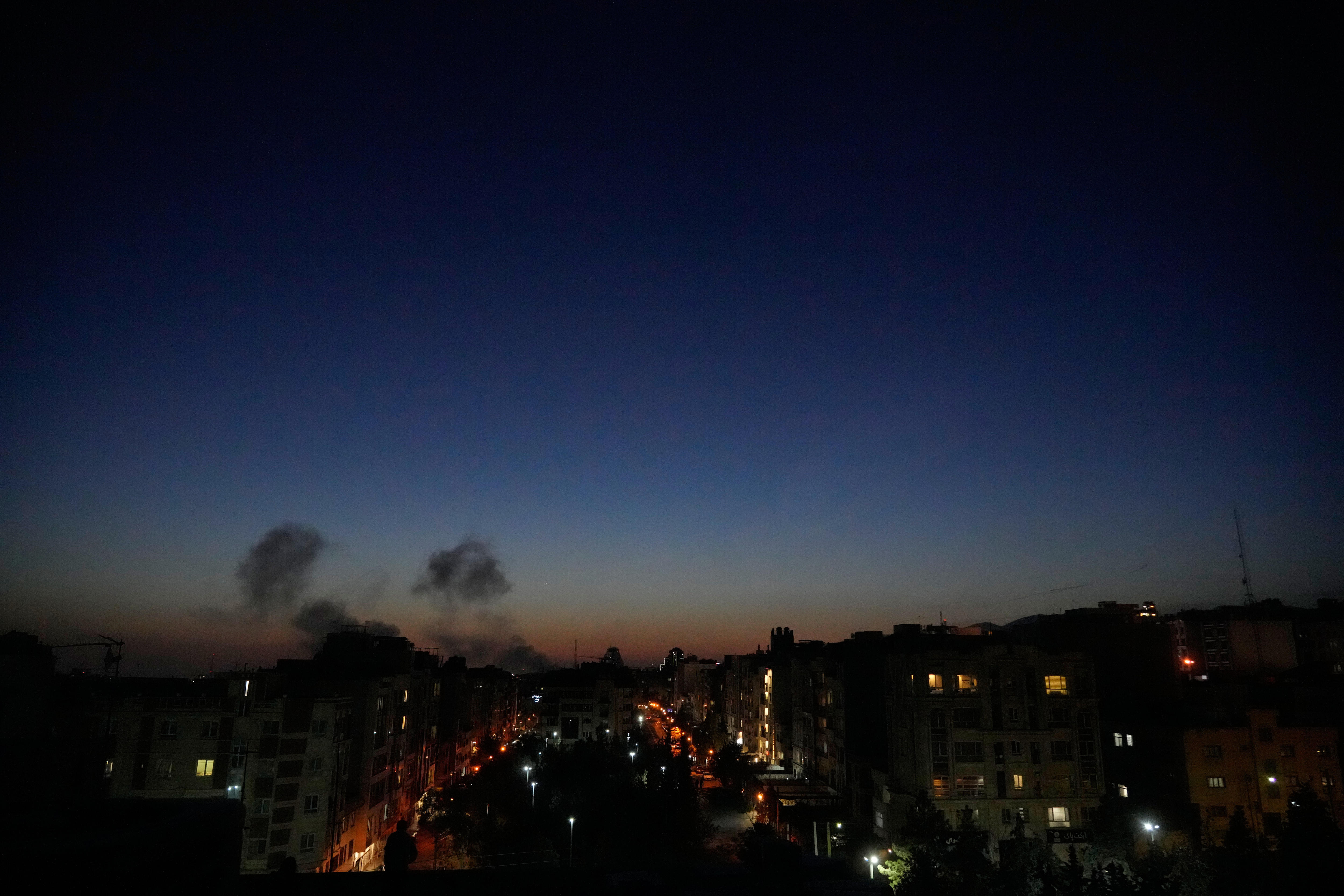 Plumes of smoke as strikes hit a city at nightfall. 