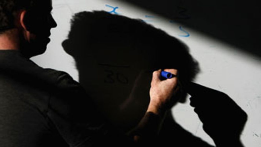 File photo: A teacher writing on a white board
