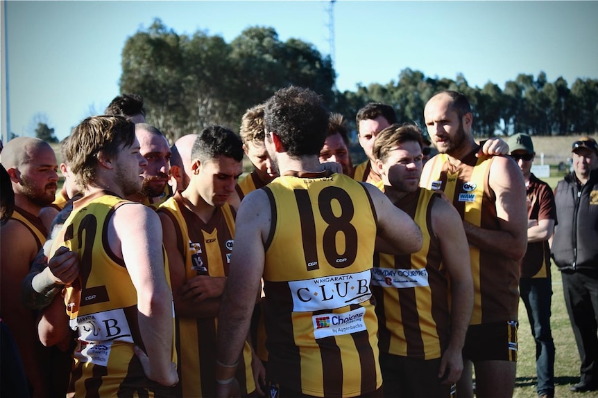 football players in a huddle