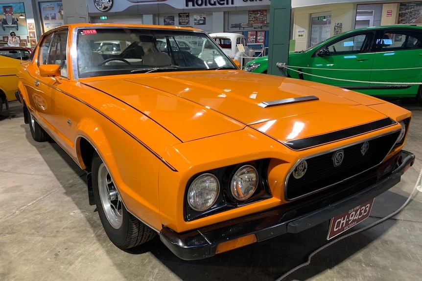 Bright orange three door coupe with hatchback 
