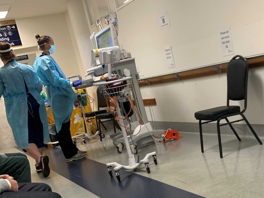 Medical staff working at machines while wearing protective gear