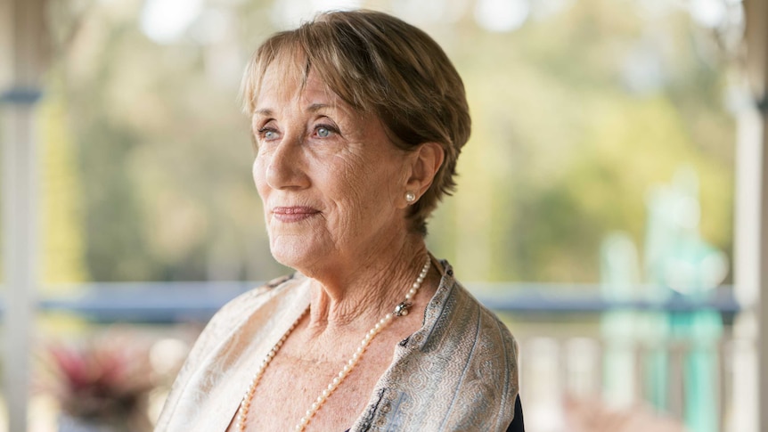 Barbara Cook, 74, stands on her balcony, looking over her backyard.